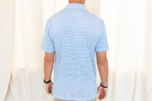 Male model wearing blue striped polo