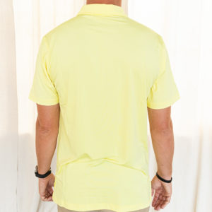 Back view of yellow polo being modeled