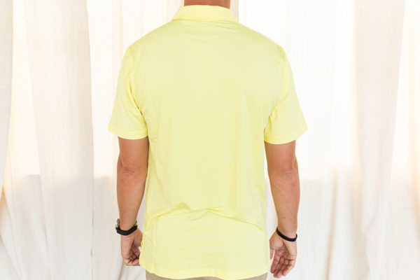 Back view of yellow polo being modeled