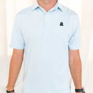 Male model wearing pastel blue polo