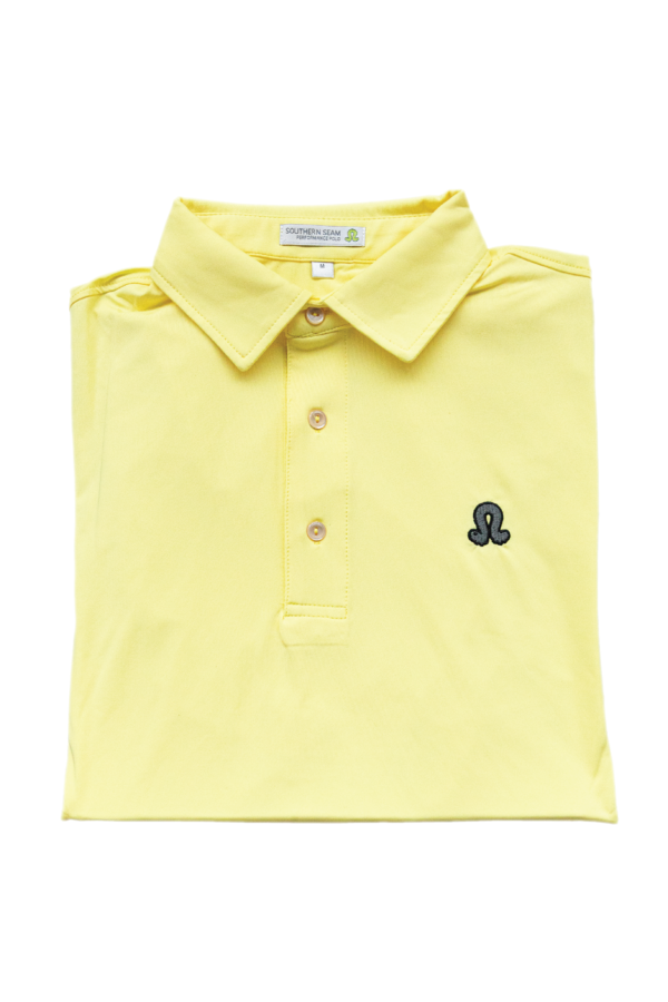 Pale yellow polo against white background
